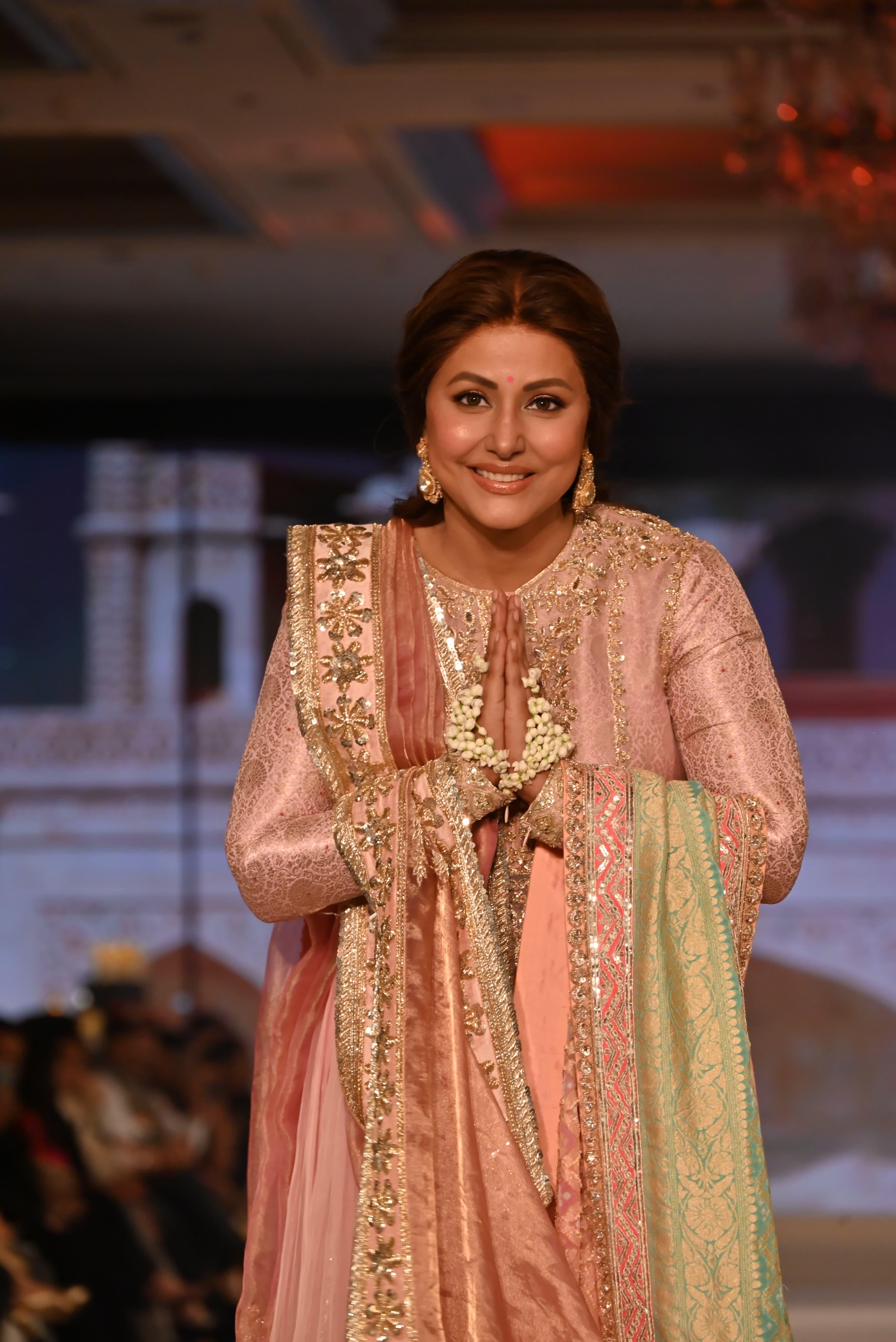 Actor Hina Khan, who is currently receiving treatment for breast cancer, walked the runway in a light pink traditional outfit.