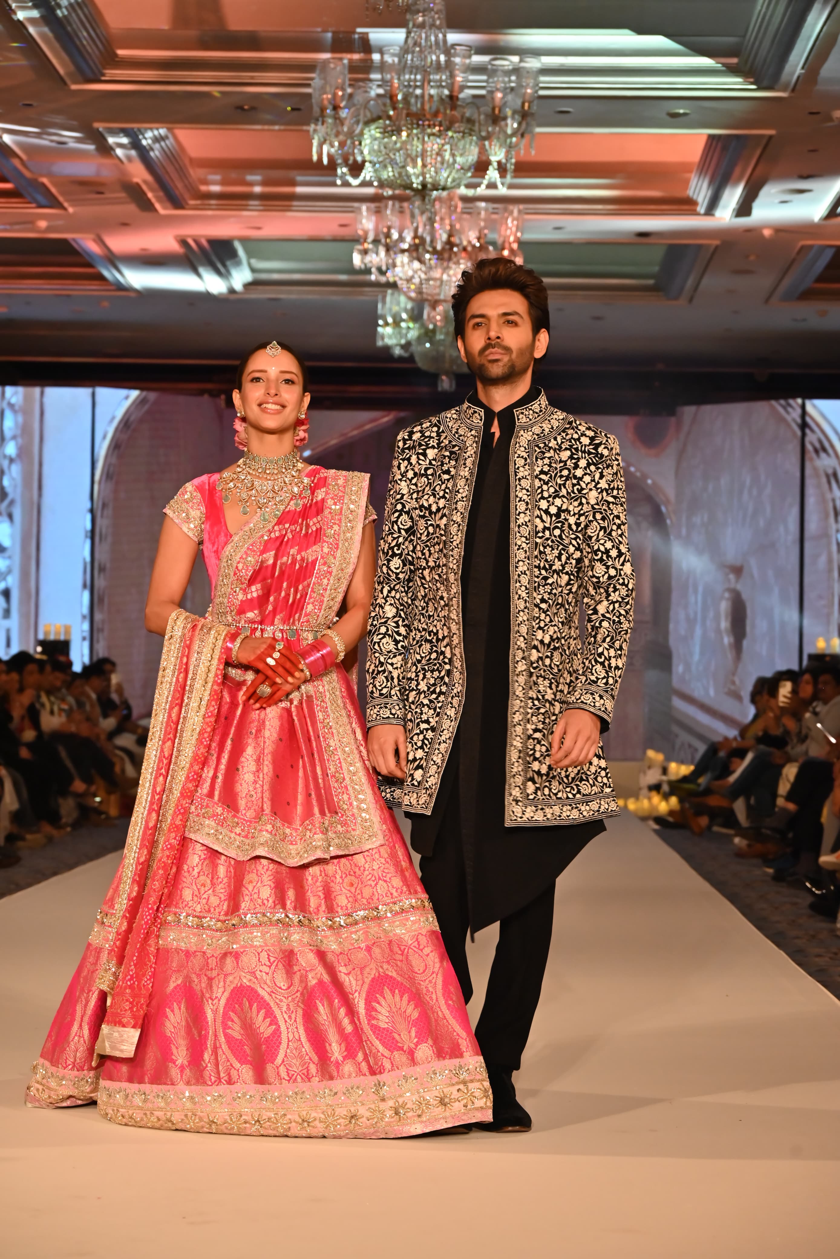 Triptii dazzled in a light pink lehenga adorned with intricate designs and heavy embellishments, while Kartik chose a stylish embroidered bandhgala paired with a black kurta and trousers.