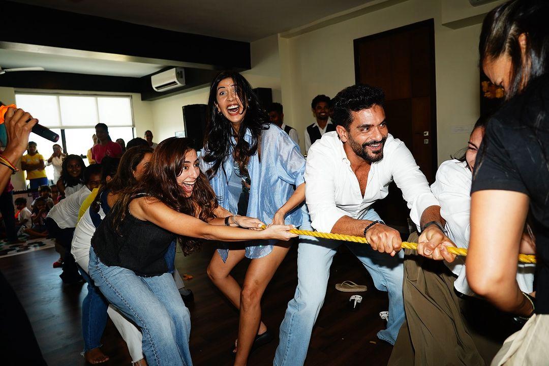 The next image shows Angad Bedi entertaining the guests with his fun antics.