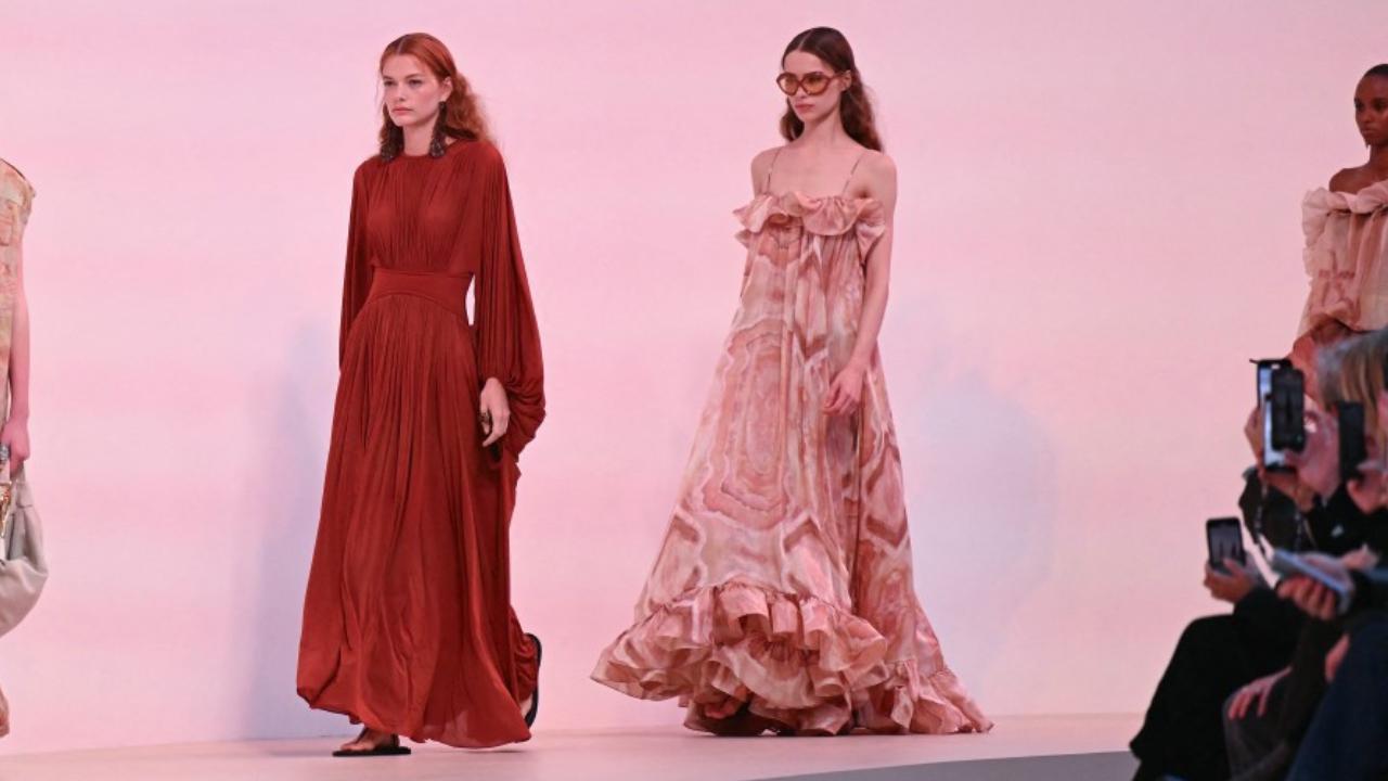 Models present a creation by Zimmermann
Spring summer 2025 is going to be full of flowery feminine prints and floaty blouses and skirts if the Paris runway shows are anything to go by. Irish designer Jonathan Anderson at Loewe won a lot of fans for his hooped flowery dresses where you could see not just the crinolines underneath, but the boxing boots too. Australian brand Zimmermann’s flowing powder-pastel dresses were given a hard edge by jackets. 