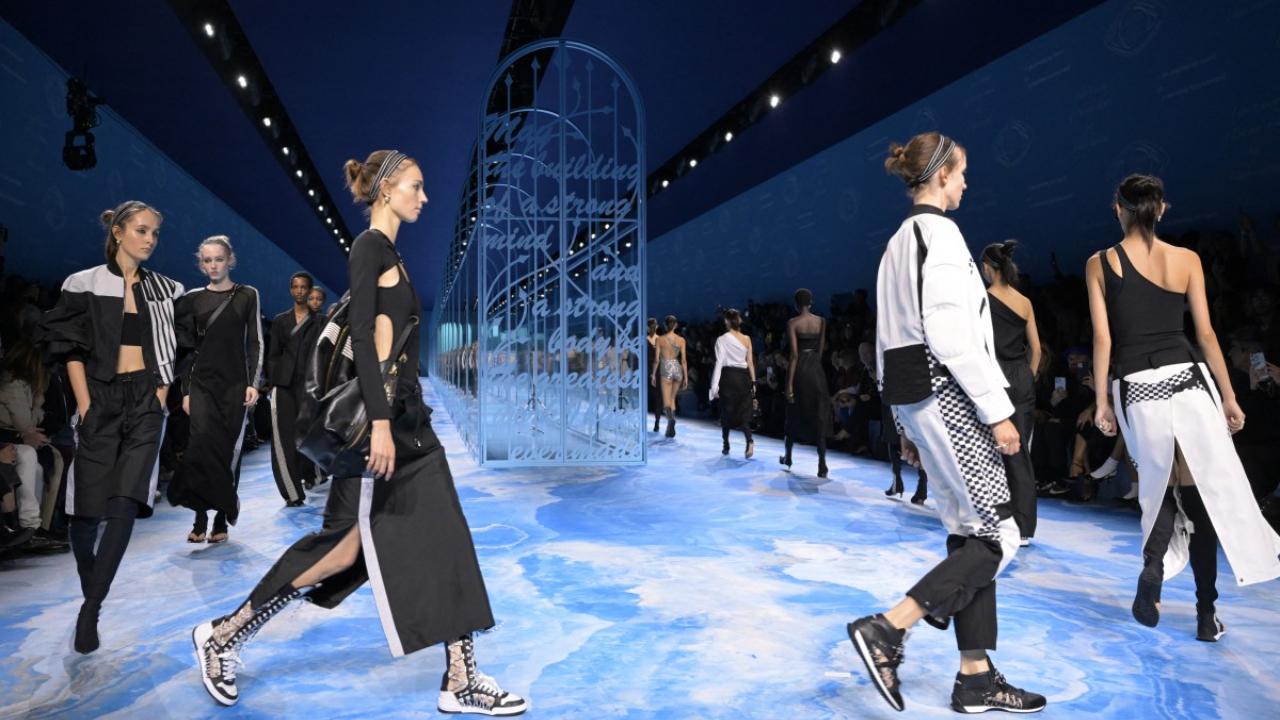 Models walk on the ramp after a presentation by Dior
Another quiet revolution is taking place on the runway. High heels have been giving way to a procession of flatter, more practical footwear.  Dior's famously feminist designer Maria Grazia Chiuri pretty much did away with heels in her collection. Sweden's Acne Studios matched its chicest business suits and skirts with imitation carpet slippers, further embedding a strong trend to liberate the comfy slipper from the style crime stocks.