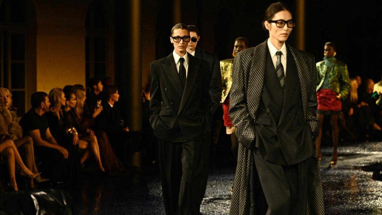 Bella Hadid and other models present a creation by Saint Laurent
Saint Laurent's Anthony Vaccarello dived into the personal wardrobe of the brand's founder, Yves Saint Laurent, to dress the models in the legendary designer's double-breasted suits. They walked in oversized men's suits nearly 60 years after the French designer revolutionised fashion by putting women in men's black tuxedos.