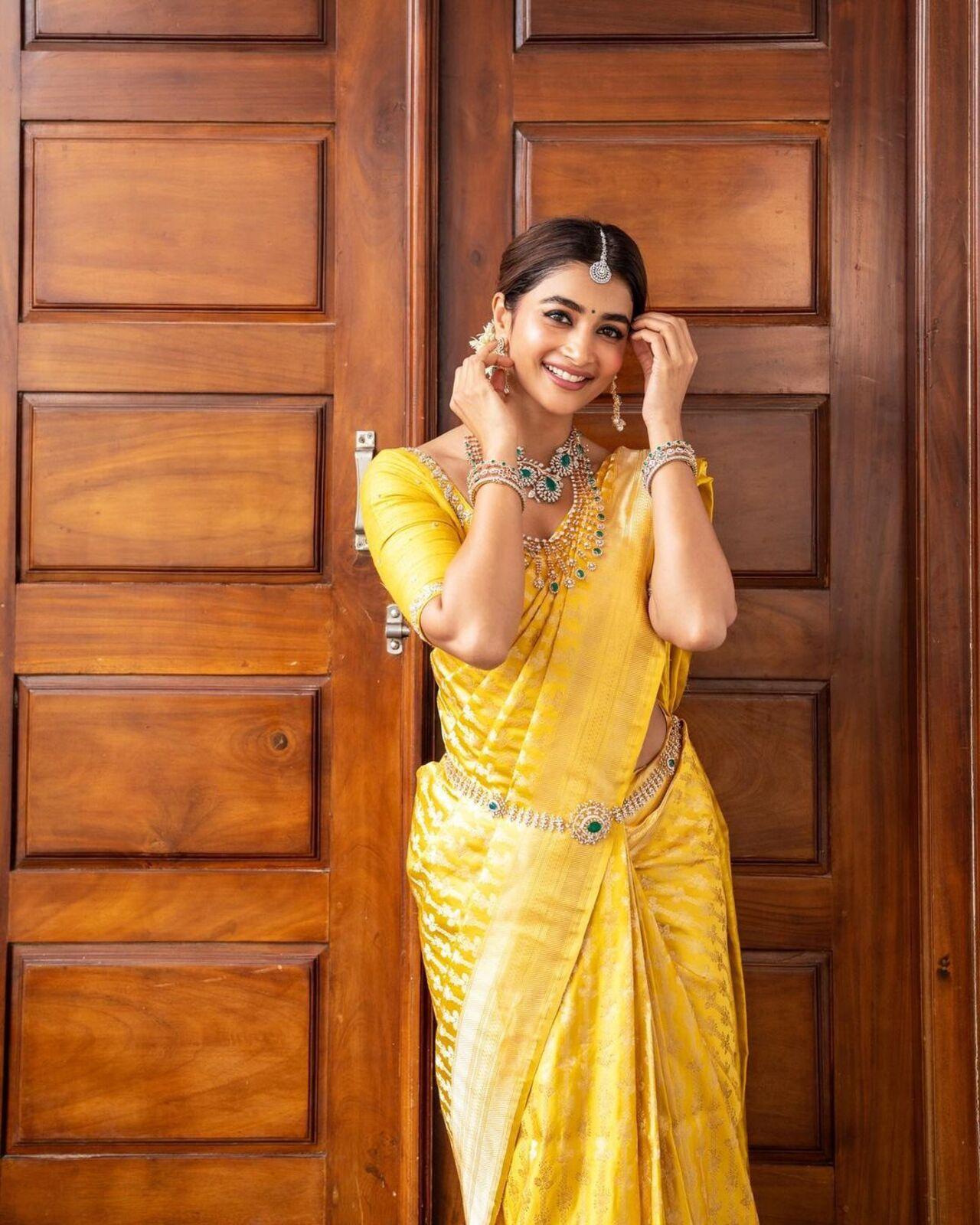 Pooja looks dreamy in this yellow south Indian silk saree