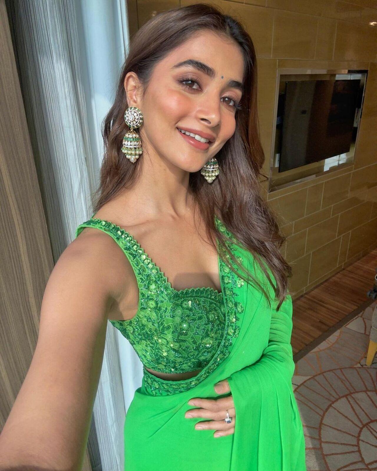 Pooja knows how to go green when it comes to clothes. She effortlessly stuns in a light green saree with delicately embroidered sleeveless blouse