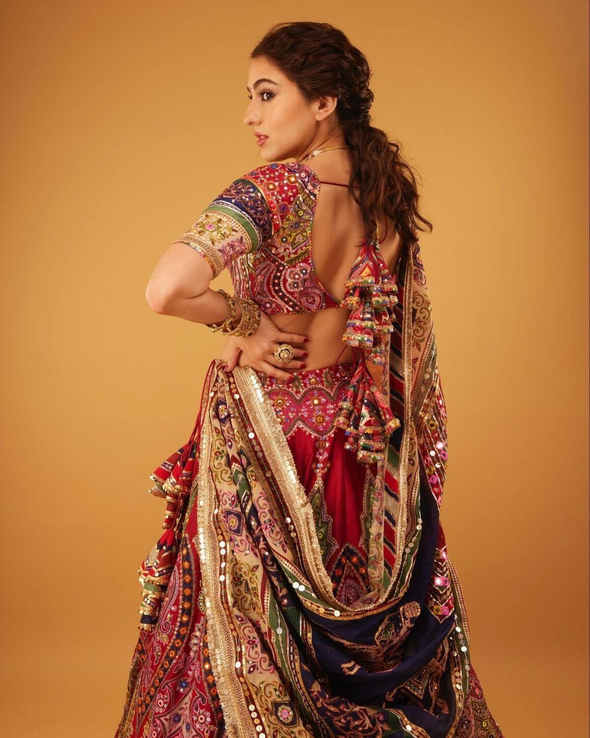 Sara Ali Khan totally aces the navratri look with the girl next door look in her heavy-work lehenga. She chose red as the base colour and enhanced the outfit with multicoloured embellishments on her dupatta and blouse truly embodying the spirit of navratri.