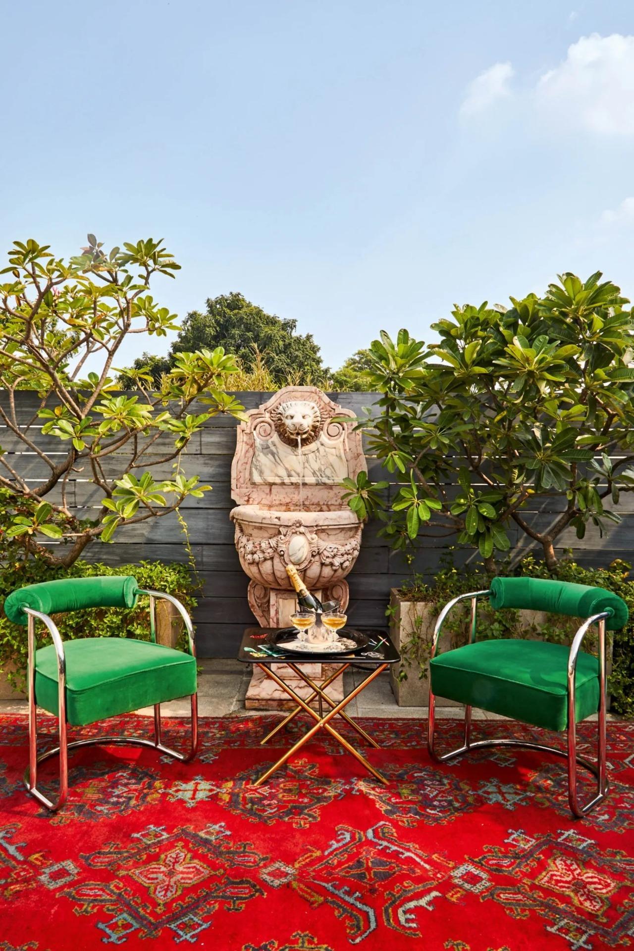 Passi's terrace is also very carefully curated with chairs by Ralph Lauren and a Fornasetti tray table. The carved Verona marble wall fountain is from Architectural Heritage