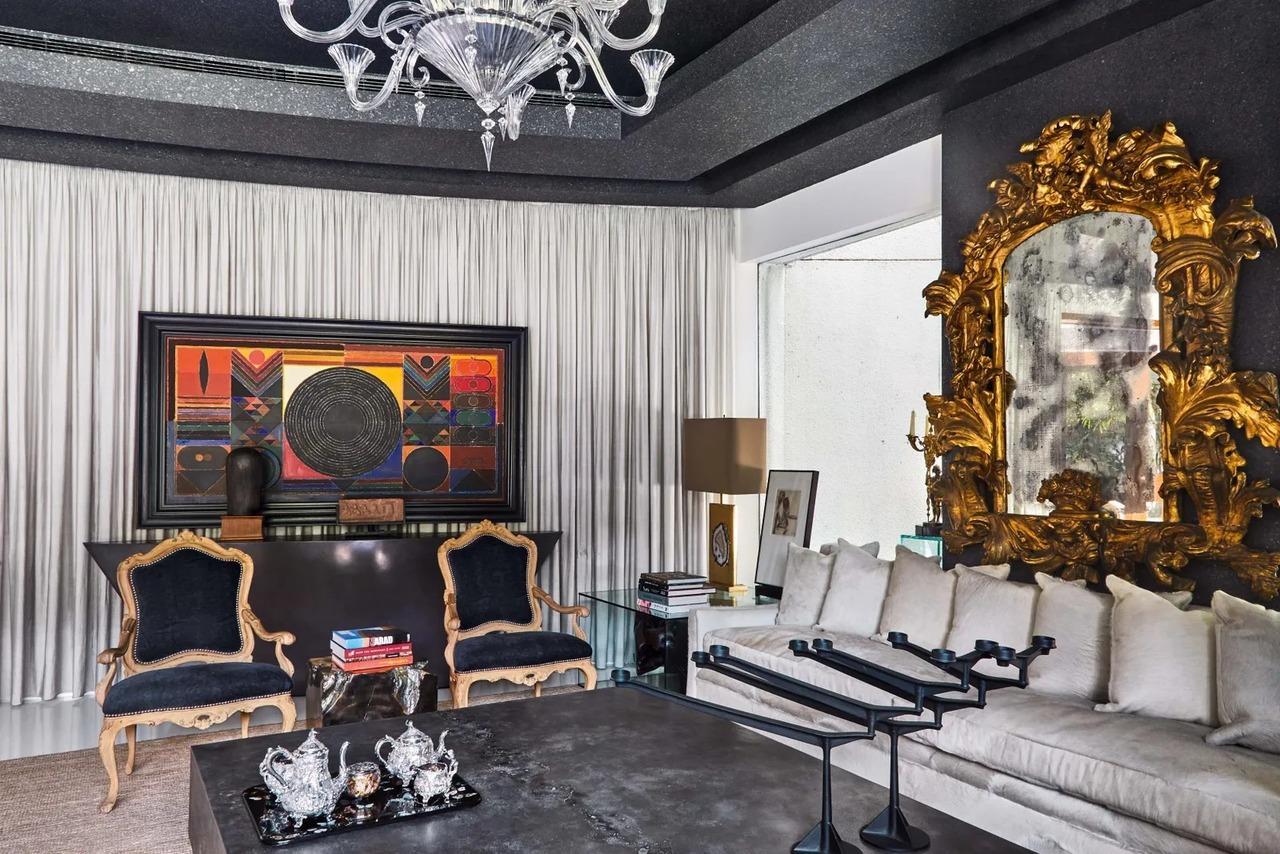 This room has a 1995 acrylic-on-canvas by SH Raza, titled Germination. On the wall adjacent to it is a 19th-century Italian gilded mirror. On top of the custom-made Based Upon coffee table are two Spin' candelabras by Tom Dixon
