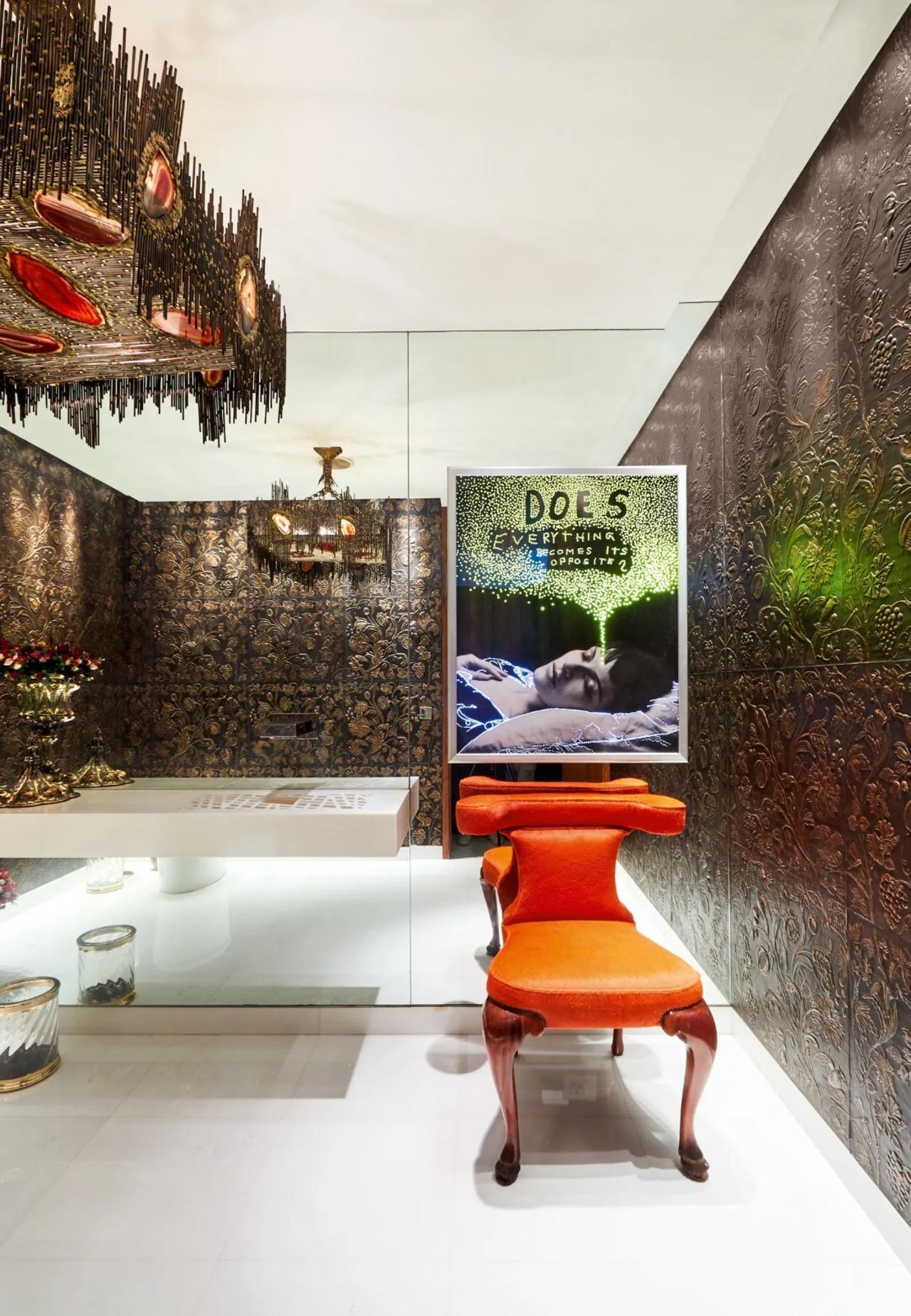 In the second bathroom, the 2009 inkjet print on archival paper mounted on a light box is by Daniele Buetti; the Eden' embossed leather panelling on the walls is from Atelier M riguet-Carr re, and the chandelier is by Claude Boeltz