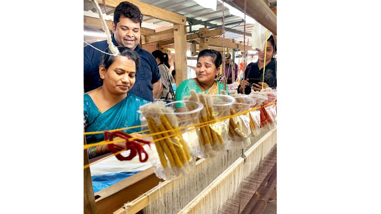 Textile artist Gaurang Shah shares a light moment with weavers at one of his jamdani units in Alikam village, Srikakulam district, Andhra Pradesh