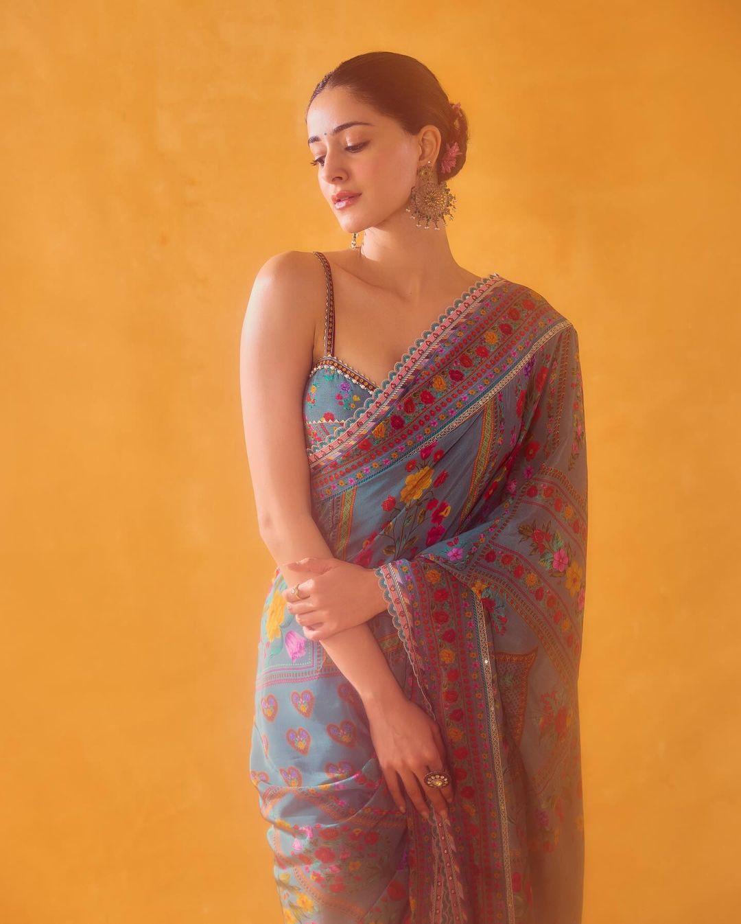 Easy, right? No hassle, and yet you can slay your Day 7 appearance by wearing a stunning blue saree with vibrant multicolor embroidery. 