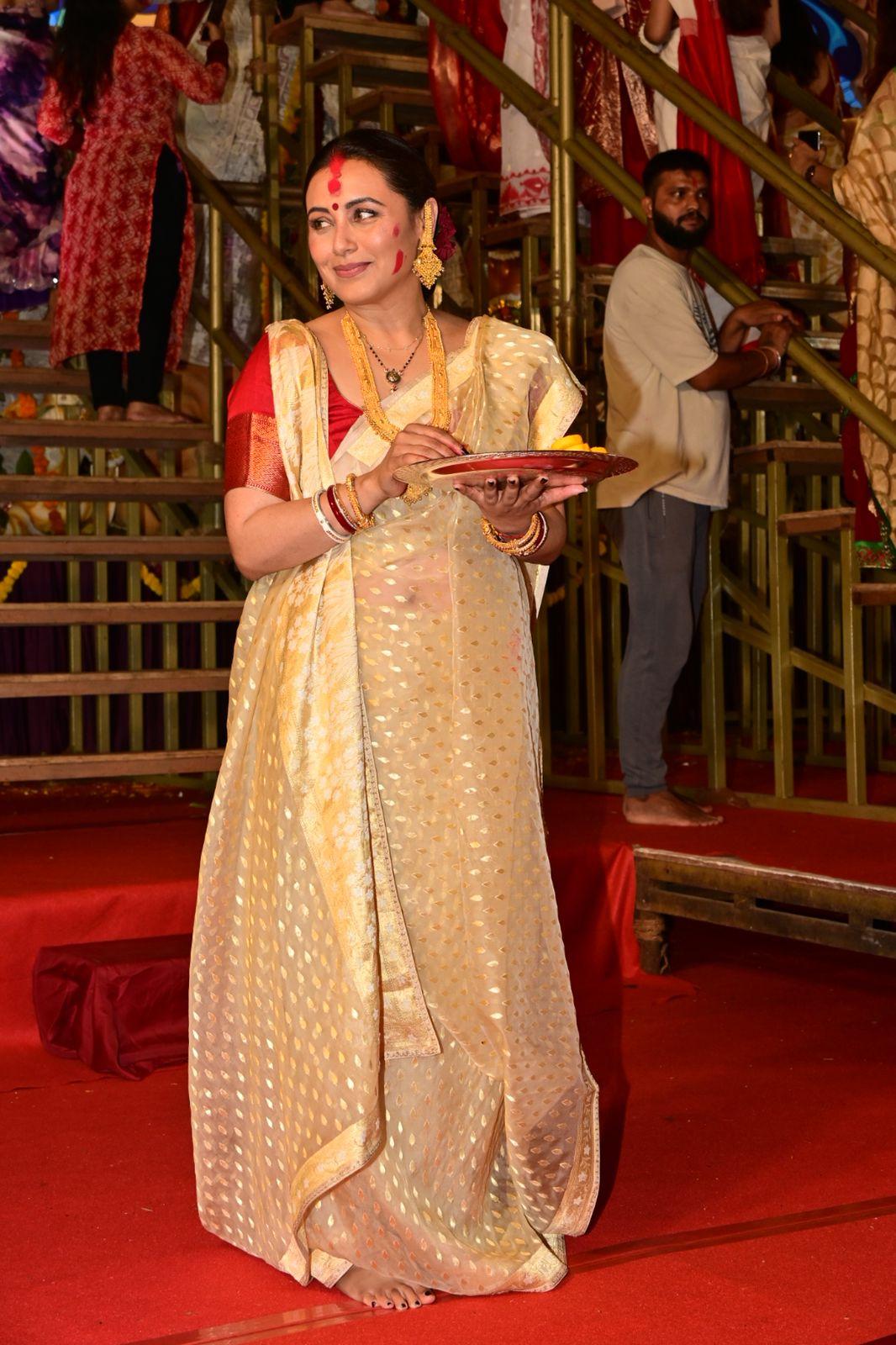 Rani Mukerji stunned in a golden saree and paired it with a contrasting red blouse