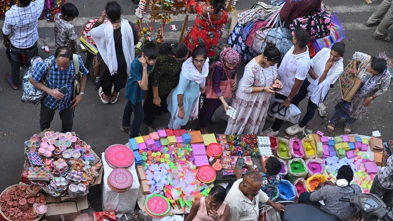 Mumbaikars purchase rangoli powders, an essential item for decorating entrances and welcoming prosperity during Diwali
