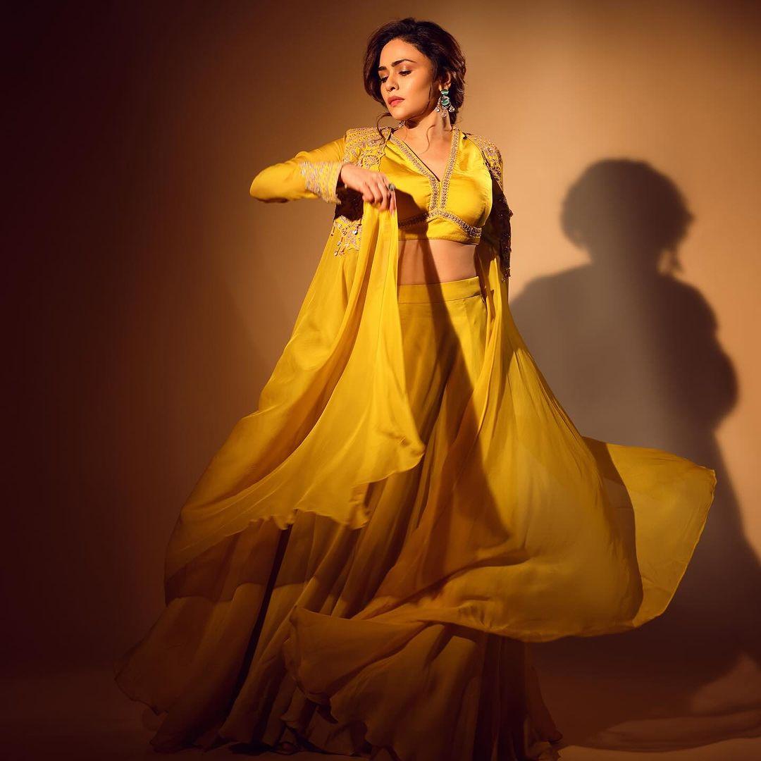 Amruta Khanvilkar wore a stunning Indo-western dress featuring a yellow crop top and matching palazzo pants, along with a shrug to finish her look