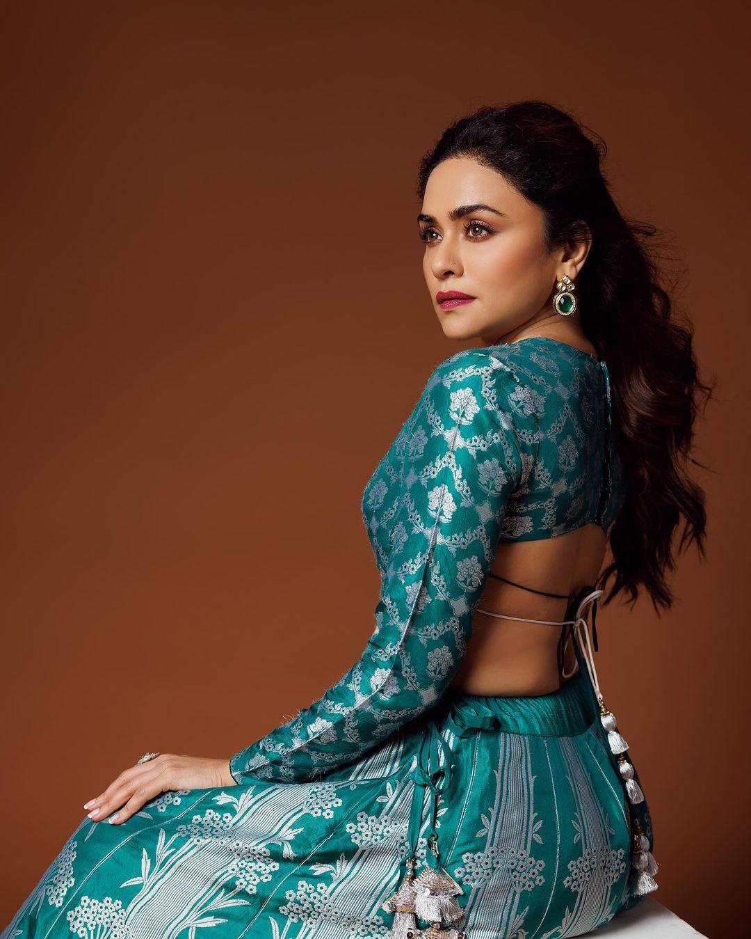 The actress wore a heavily embroidered lehenga paired with a full-sleeve blouse featuring intricate prints all over it. The blouse has a backless design, and the matching dupatta perfectly complemented the overall appearance