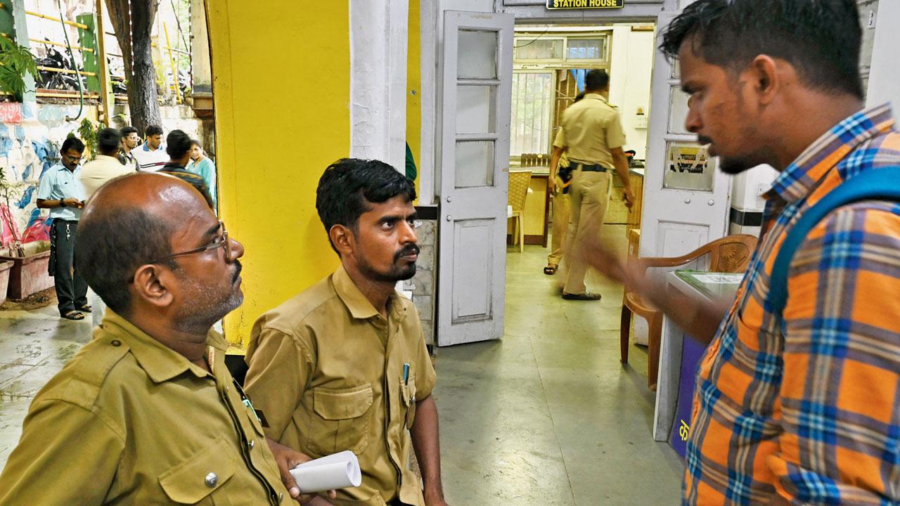 The BEST bus driver (left) and conductor at the police station