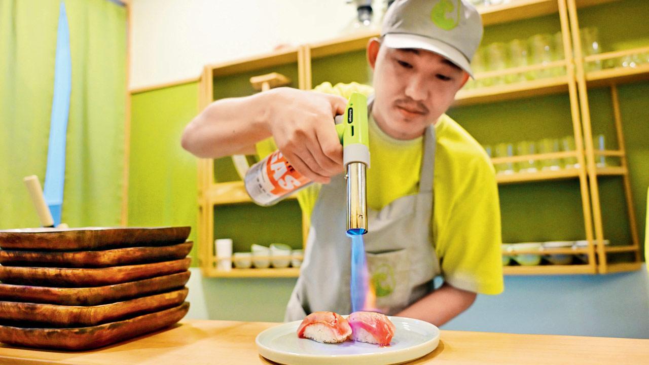 A chef works on a yellow fin tuna. Pics/Shadab Khan