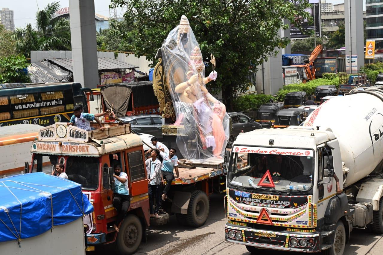 Devotees transport the idol on the busy Western Express Highway in Mumbai on Thursday  