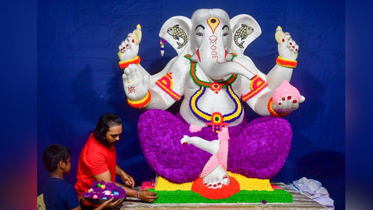 An artist makes an idol of Lord Ganesha with cotton balls and threads for the upcoming Ganesh Chaturthi Festival, in Mumbai.