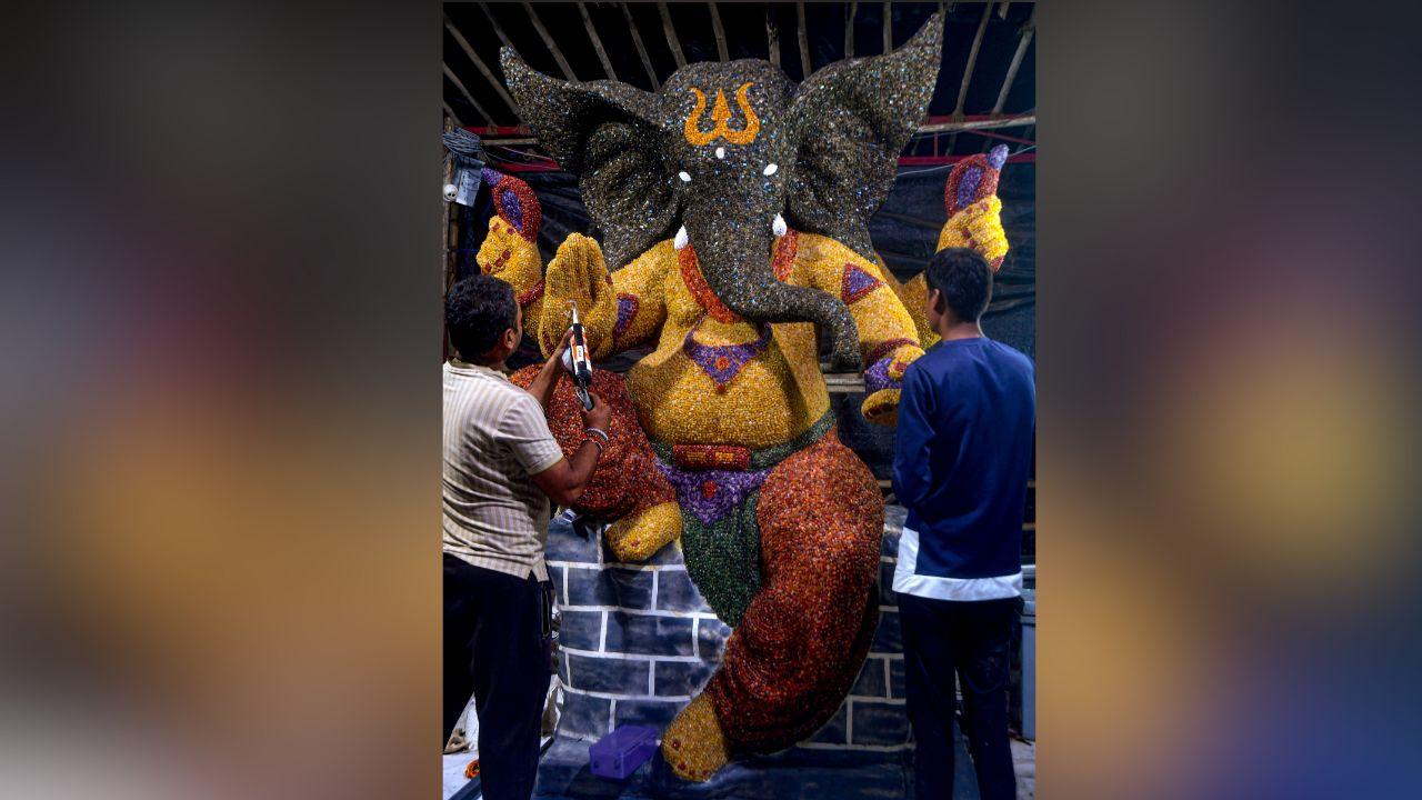 Artisans give finishing touches to an idol of Lord Ganesha made from colourful stones ahead of Ganesh Chaturthi festival, in Mumbai. 