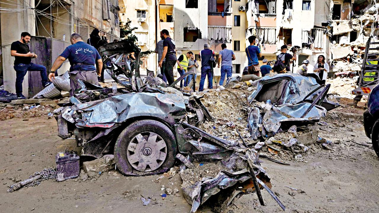 Emergency workers clear the rubble at the site of an Israeli strike in a southern suburb of Beirut