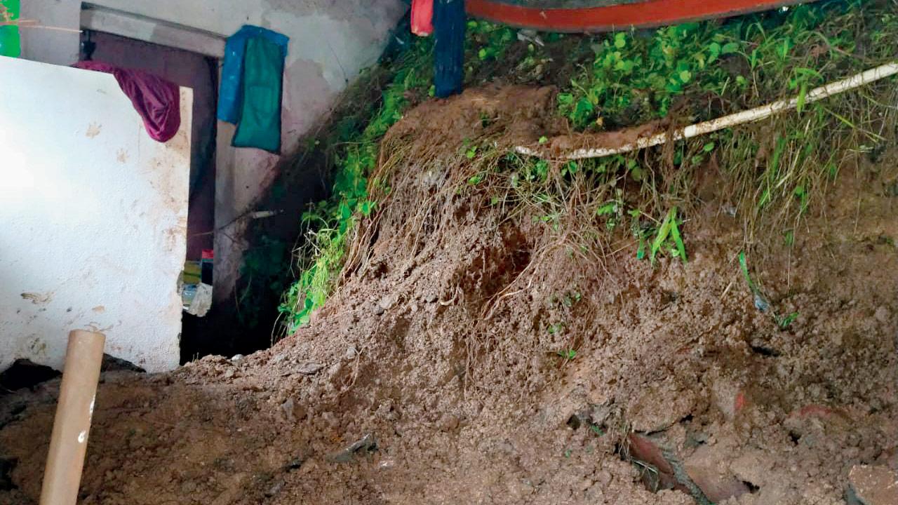 Mud and debris pile up inside the home of Madhuri Sharma