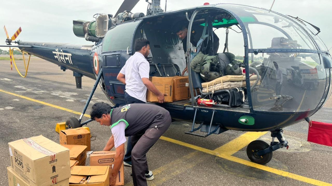 Indian Naval helicopters drop 1,820 kg of food packets, 22 kg medicines in flood-hit areas of Andhra Pradesh