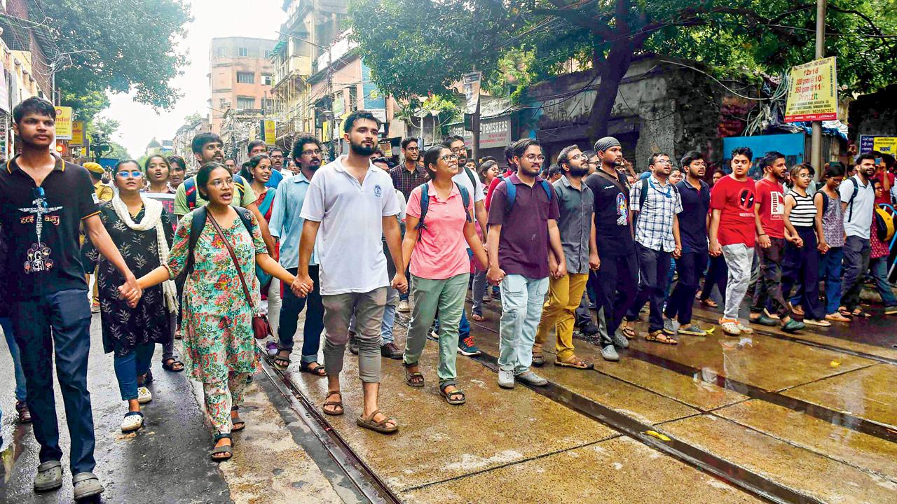 Protesting junior doctors march towards Lalbazar police headquarters. Pic/PTI
