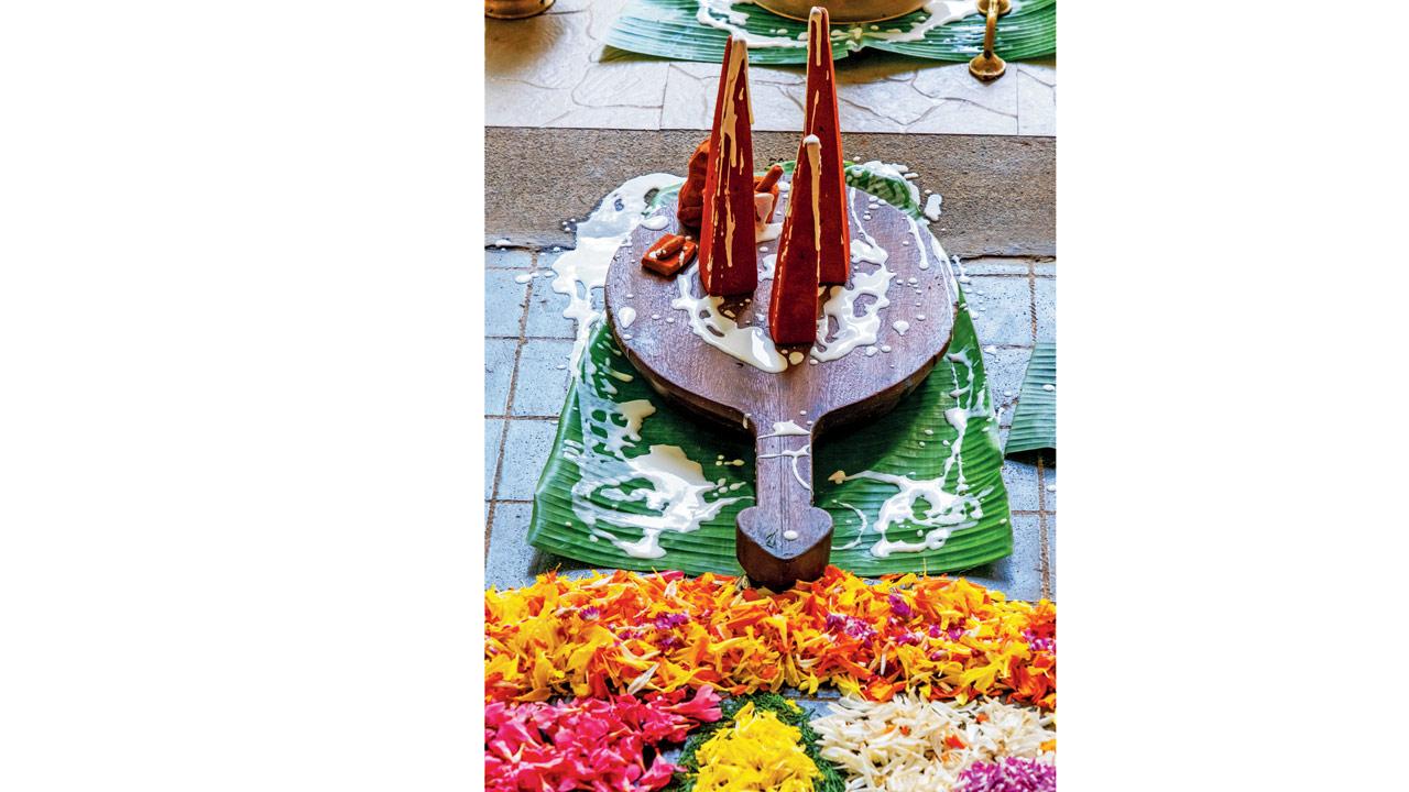 Onathappan or Madhera sprinkled with rice flour in water. The pyramid-shaped clay figurine is a traditional idol associated with Onam and once represented Lord Vishnu but is now associated with the demon king Mahabali and his return from the netherworld during the festival to visit his people