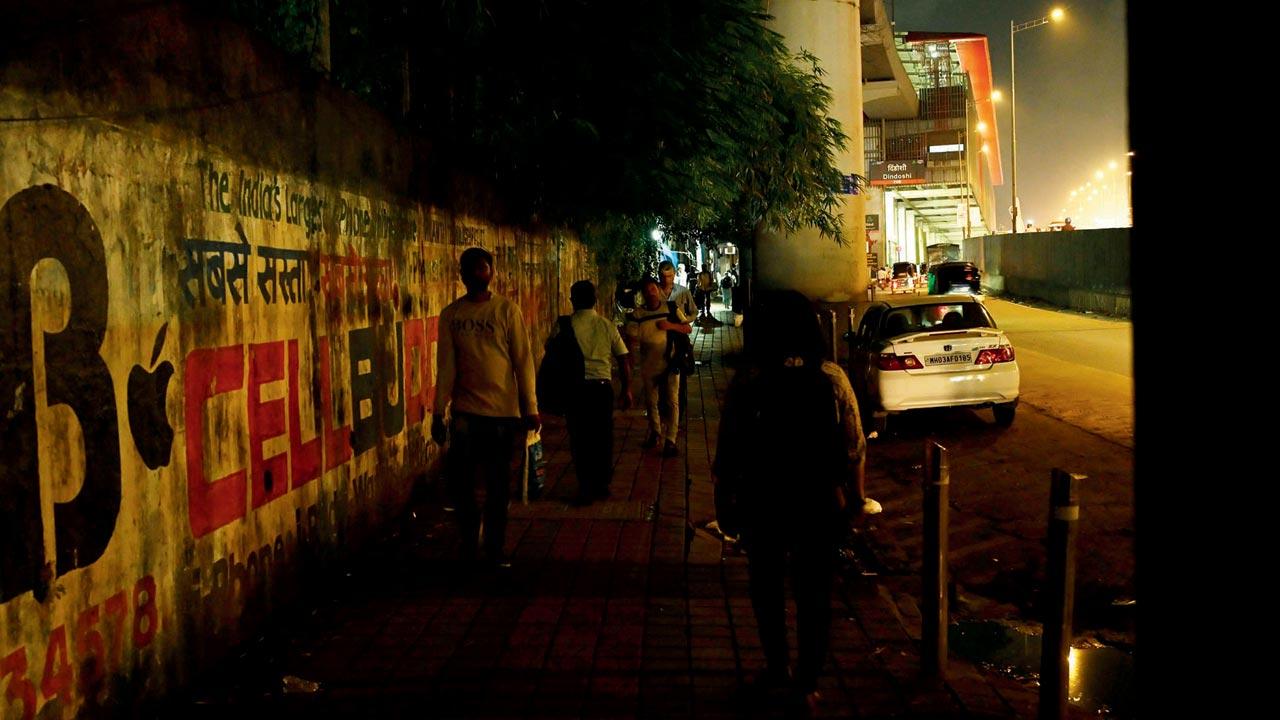 A dimly lit, broken footpath outside Dindoshi Metro station. Pics/Satej Shinde