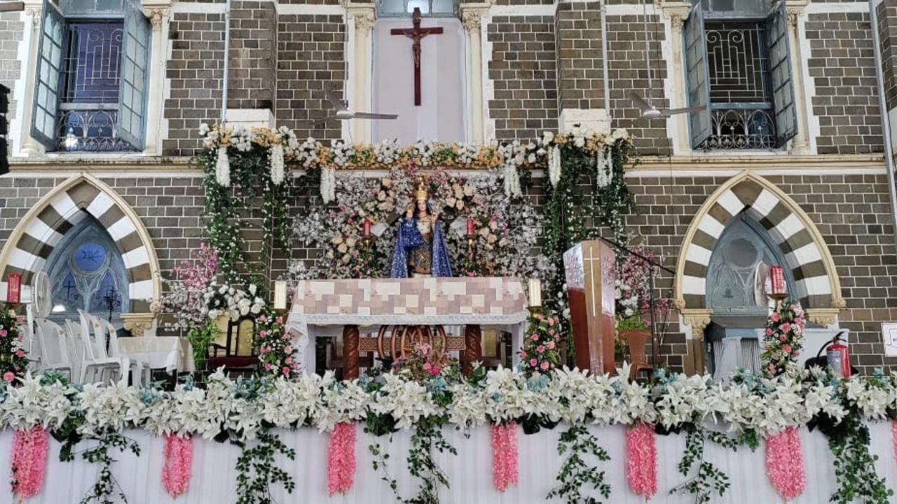 It is not only the altar inside the church but also the one outside that has been decorated with a pink and white theme as people spend time in prayer there.