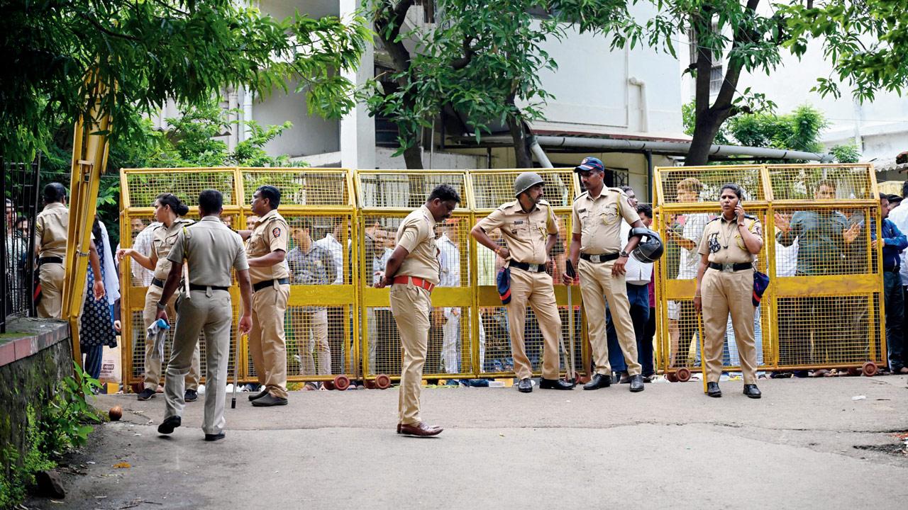 Cops cordon off the area near Badlapur station following the massive protests