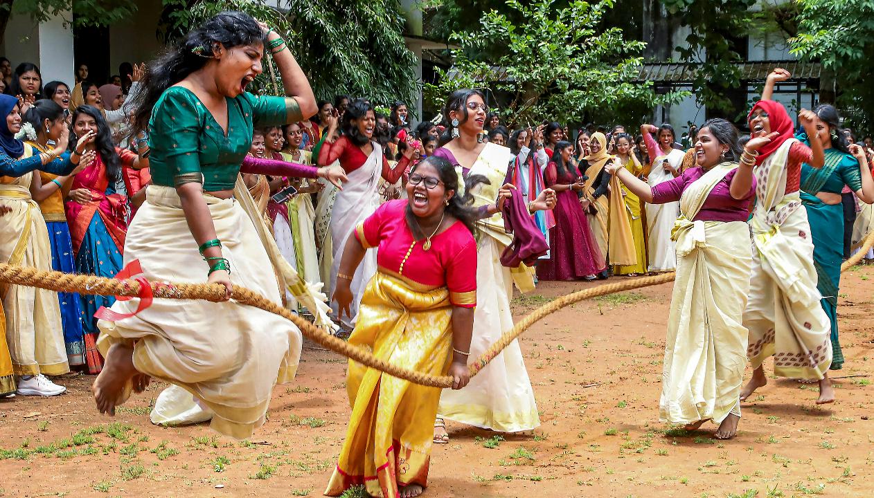 Students celebrate after winning the tug of war competition during Onam celebrations, at a Government Women's college in Thiruvananthapuram, earlier on Thursday.