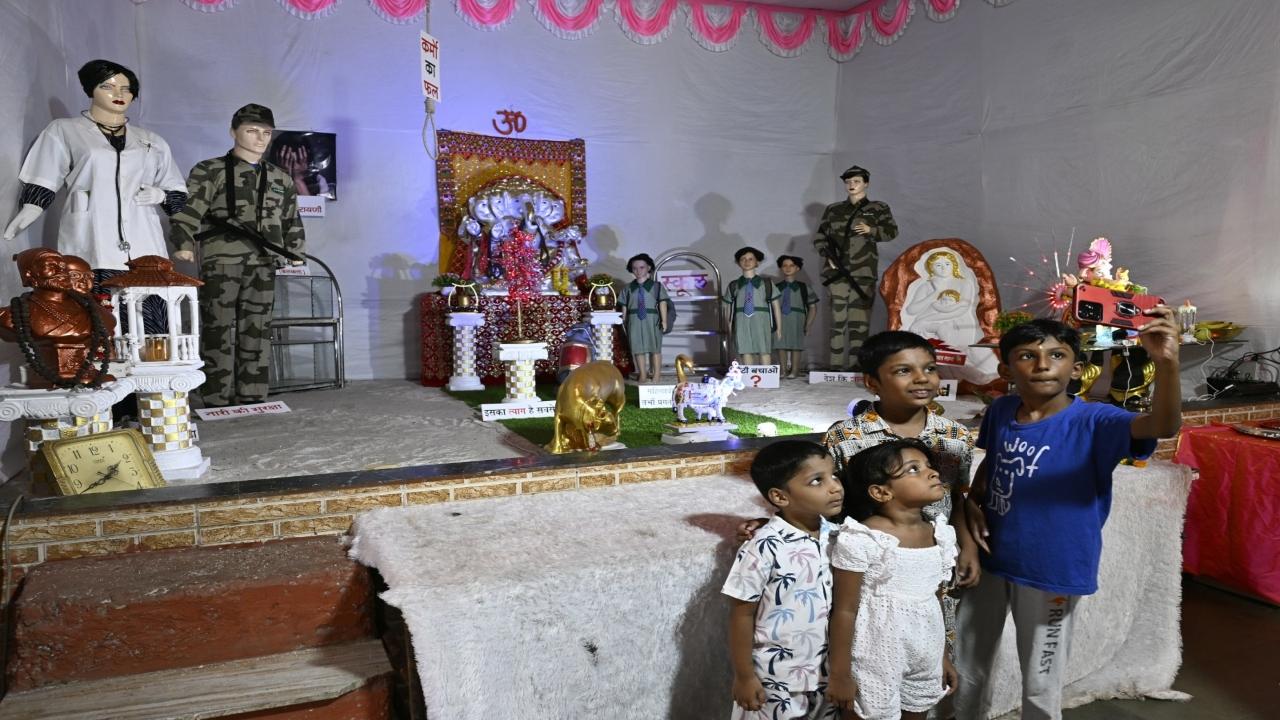 Young devotees take a selfie at the pandal