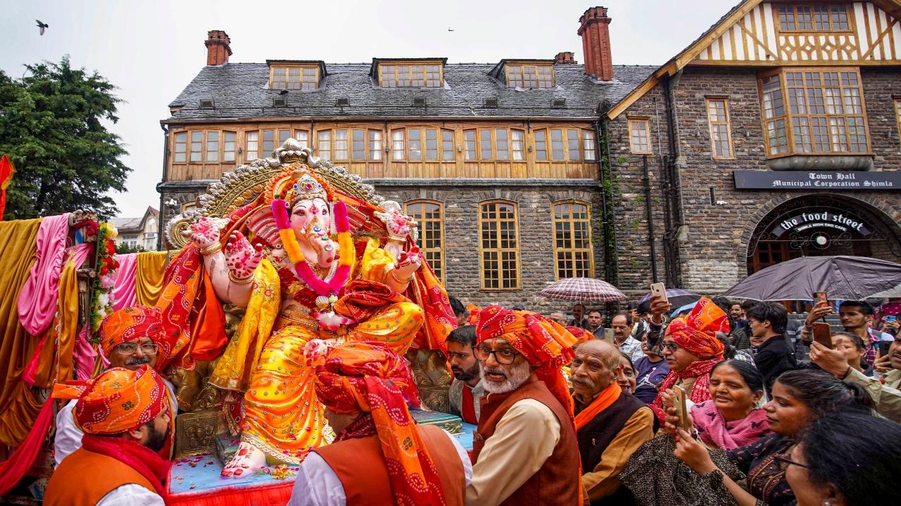 Devotees take a Ganpati idol to a pandal in Shimla