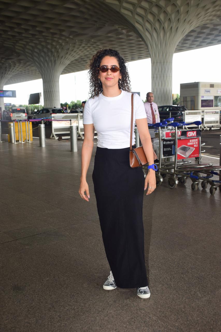 Take cues from Sanya Malhotra and slay your airport look in a simple white top paired with black pants