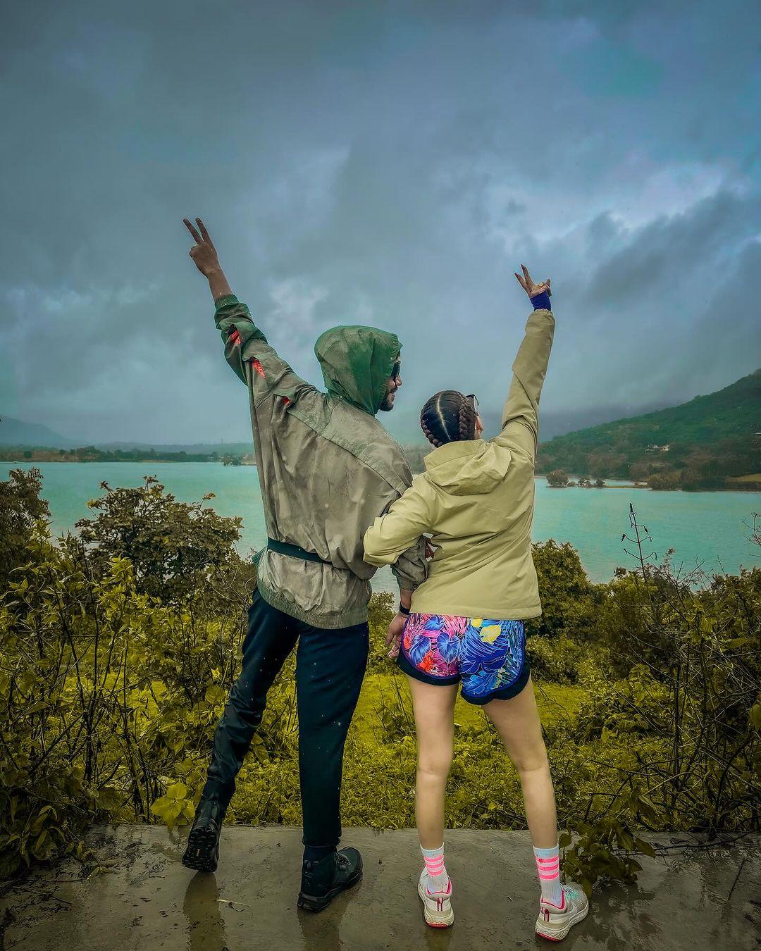 In this picture, Ankita Lokhande can be seen wearing apple-cut shorts paired with a brown jacket, while Vicky Jain complements his lady love in black pants paired with a green jacket