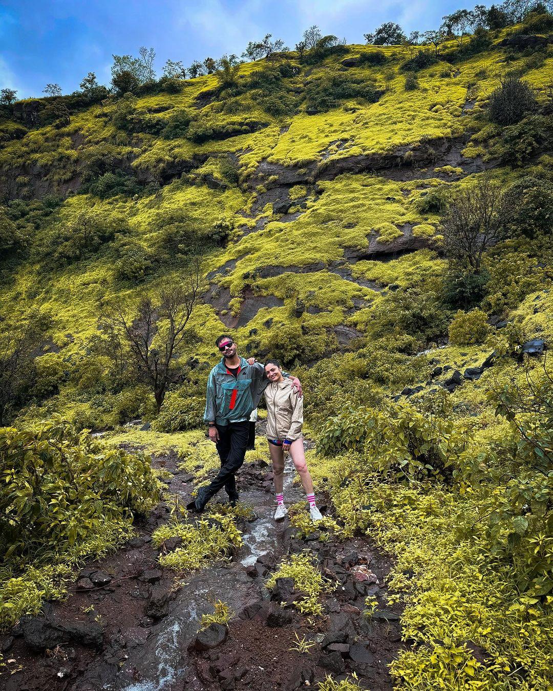 The couple traveled to a picturesque location filled with greenery