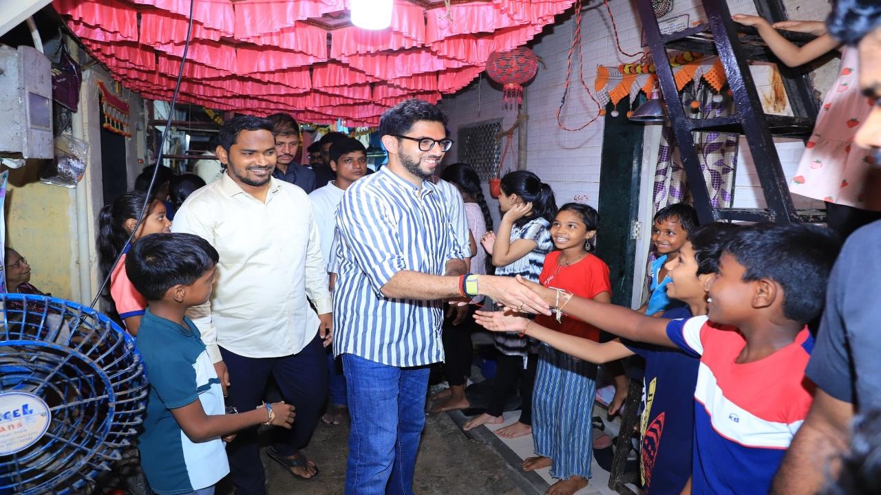 Former Maharashtra Minister Aaditya Thackeray meets kids during a visit to the Ganpati mandal at Janata Colony in Worli