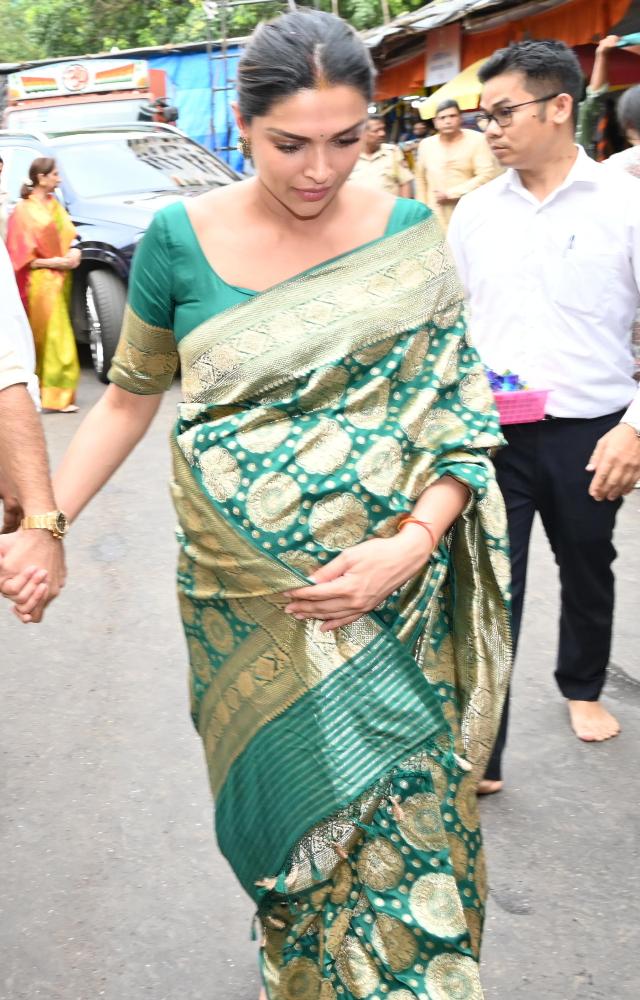 Deepika Padukone looked stunning in a green and golden saree, paired with a half-sleeve, round-neck green blouse.