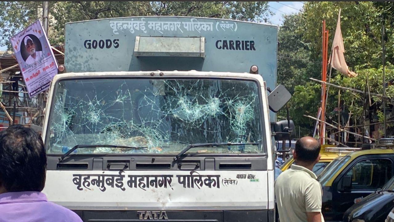 During the demolition attempt, tensions heightened as protesters pelted stones at a BMC vehicle, resulting in its vandalism.