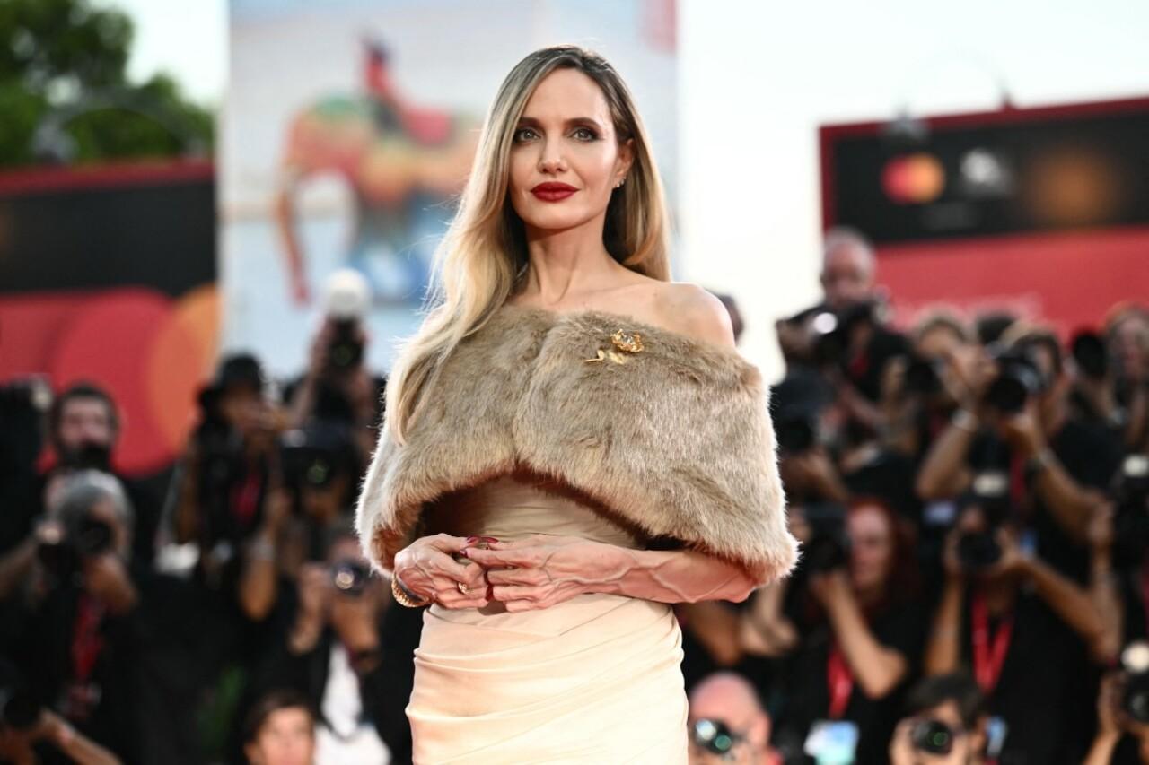 Angelina Jolie took the Venice Film Festival by storm by attending the premiere of her movie 'Maria'. She wore a custom-made beige gown with a fur stole wrapped around.