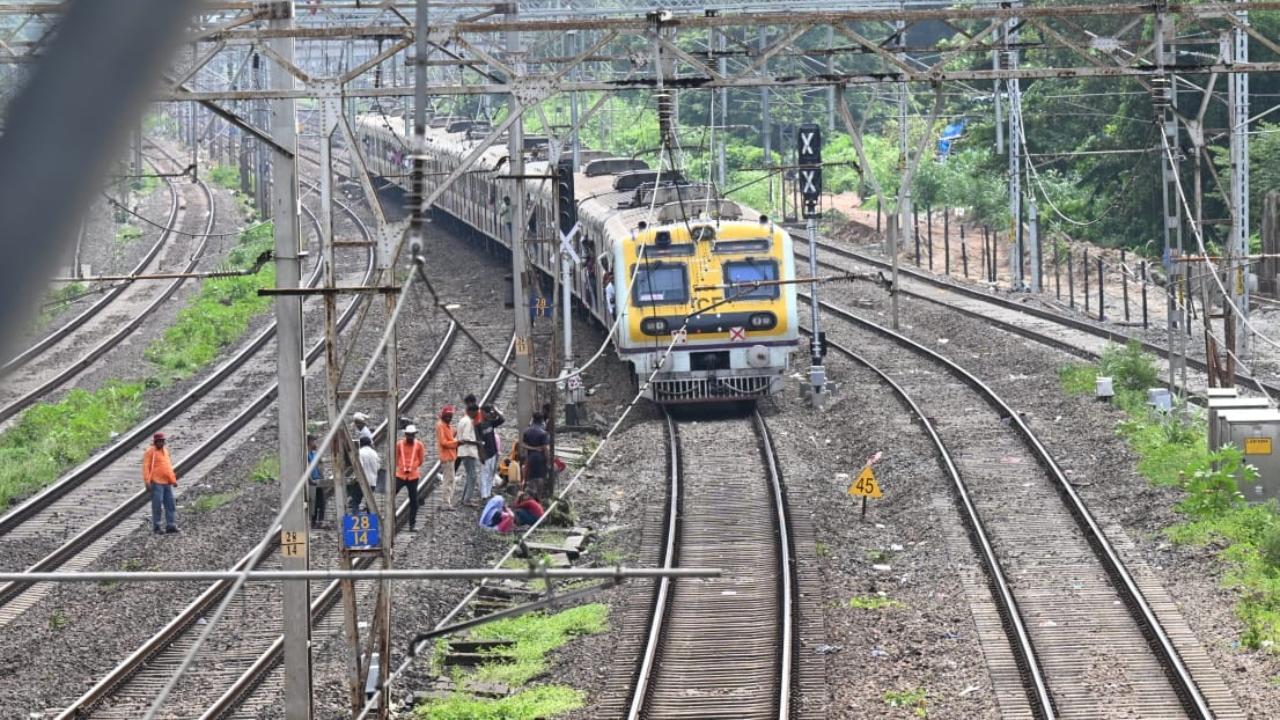 Workers were on Sunday seen working on the railways tracks near Malad station. Pics/Satej Shinde