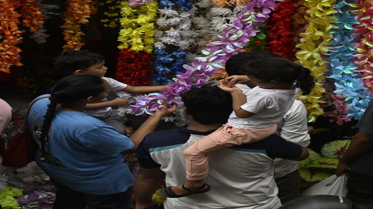 A family checks out the decorations for installing Bappa's statue at home