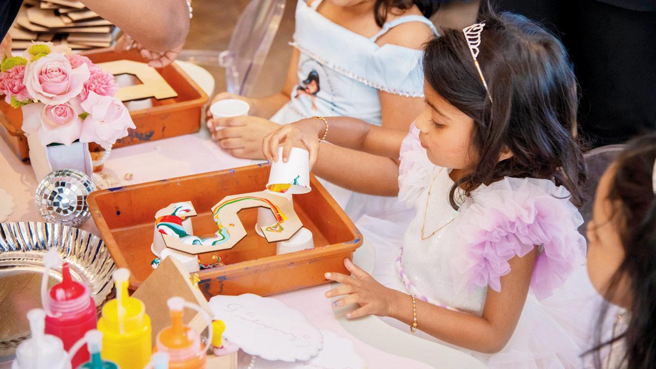Kids indulge in art as they paint their initials