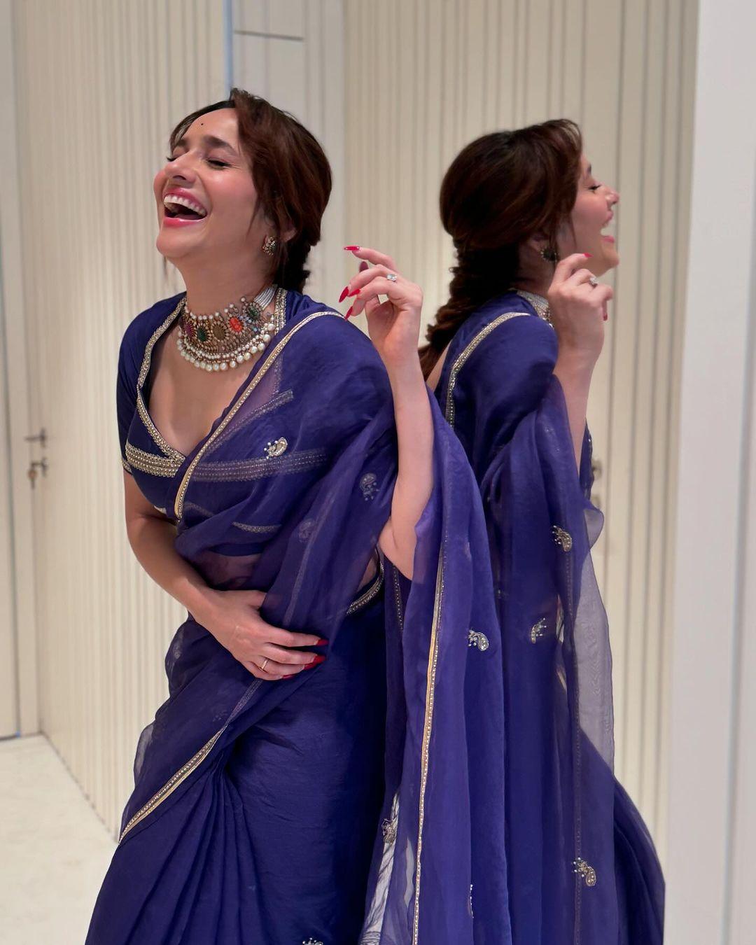 Ankita Lokhande is wearing a beautiful sheer blue saree with golden lace. The actress paired her saree with a stunning blouse, and this look is perfect if you’re still confused about what to wear on Day 7