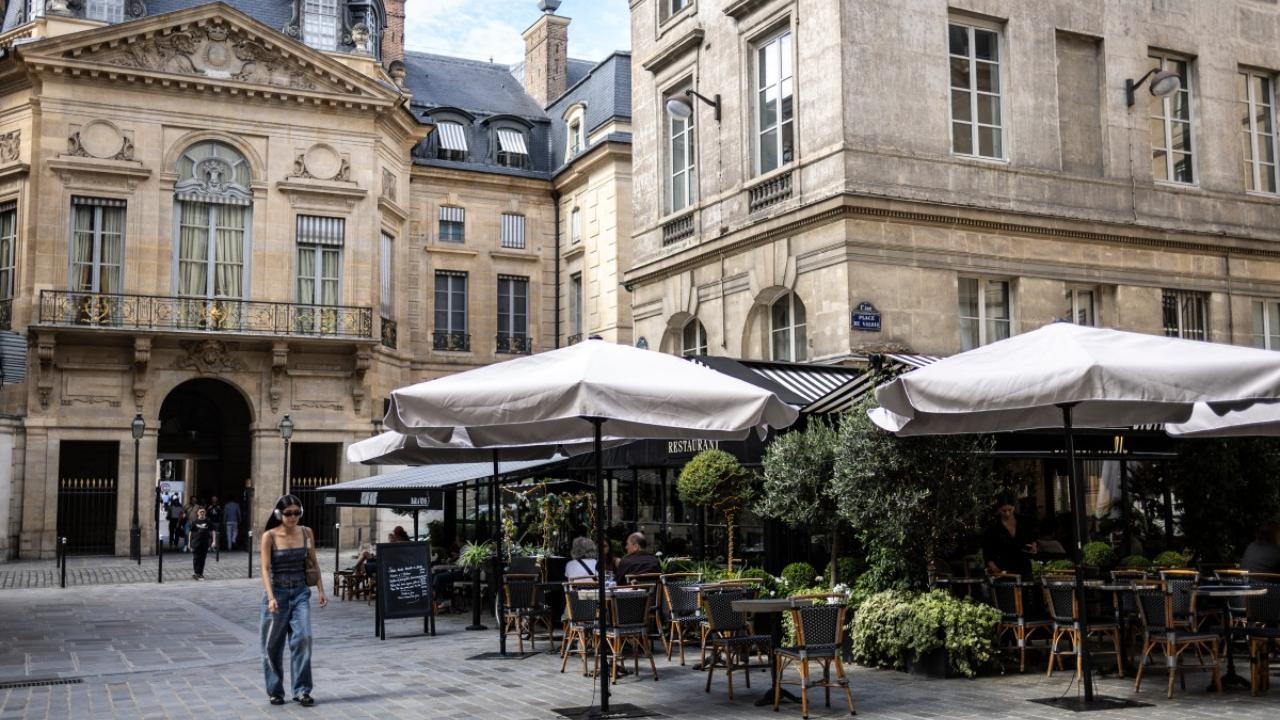 A woman walks near Bistro Valois in Paris