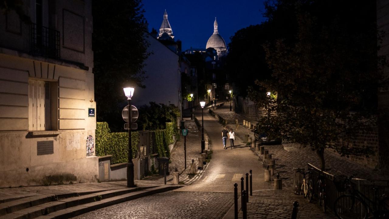 A couple walk along Rue de l'Abreuvoir in Montmartre