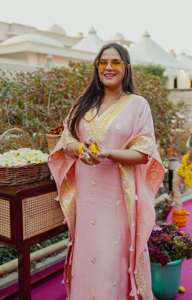 In a picture from the couple`s Haldi ceremony, Richa can be seen wearing a beautiful pink outfit with yellow embroidery