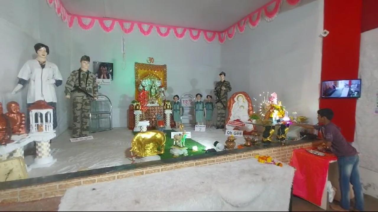 A child takes Bappa's blessings at the pandal
