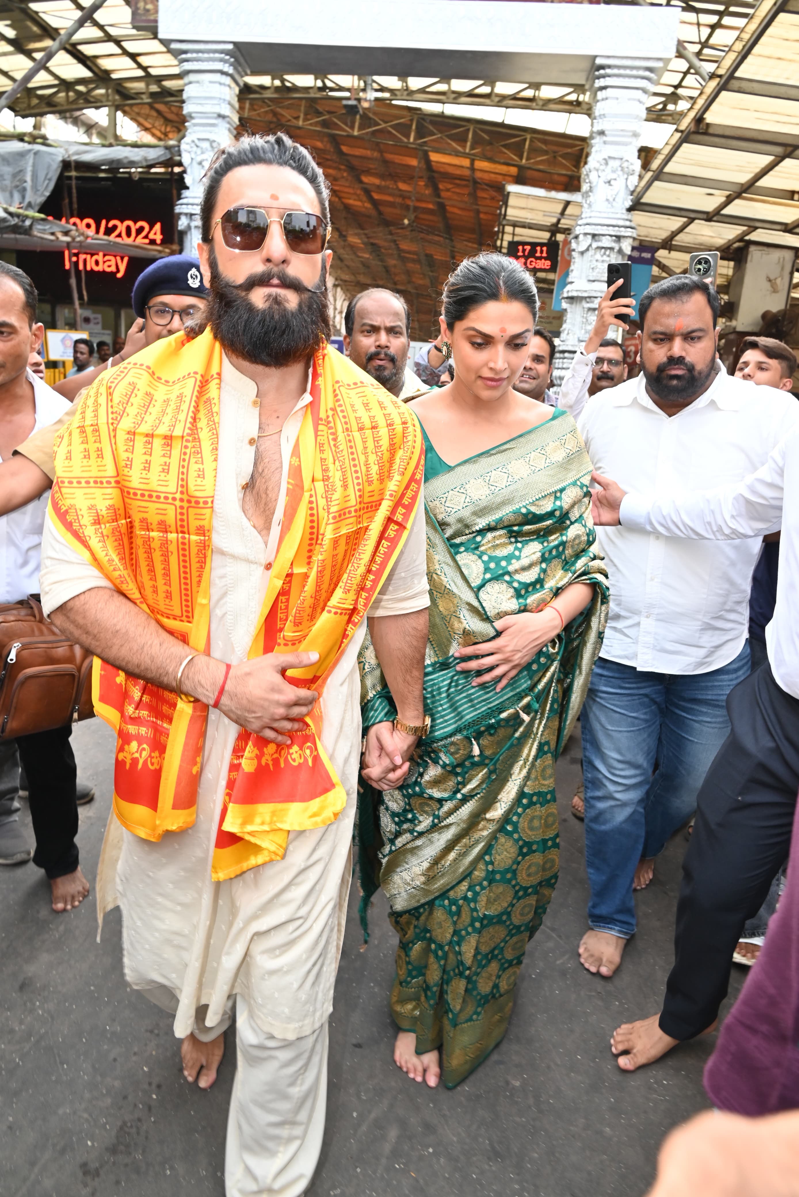Always the supportive hubby, Ranveer Singh made sure Deepika felt protected among the hundreds of people present at the temple